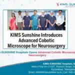 KIMS Sunrise Hospitals banner announcing an advanced cobotic microscope for neurosurgery, with a group of doctors posing in front of it.