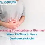 Person holding abdomen with a stomachache text asks about recurring constipation or diarrhea and when to see a gastroenterologist